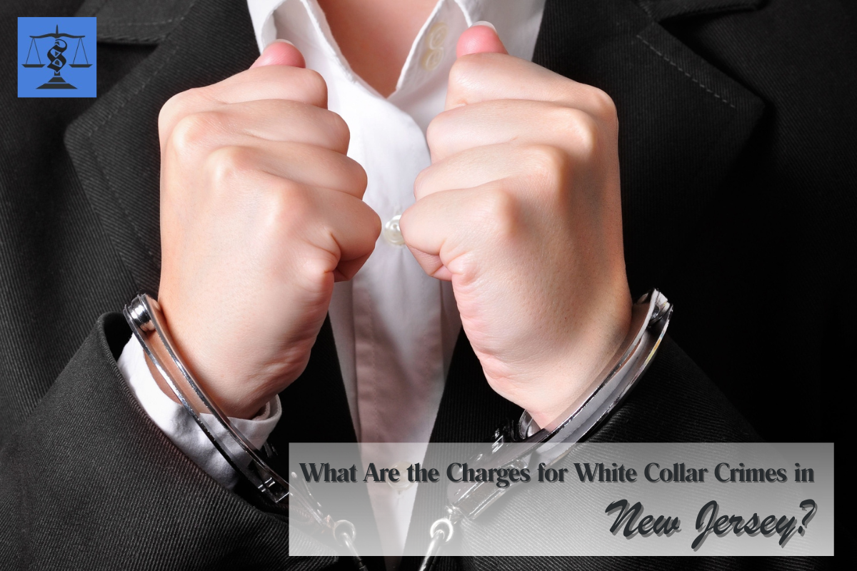 A man is handcuffed. He is wearing a white collar. His face cannot be seen.